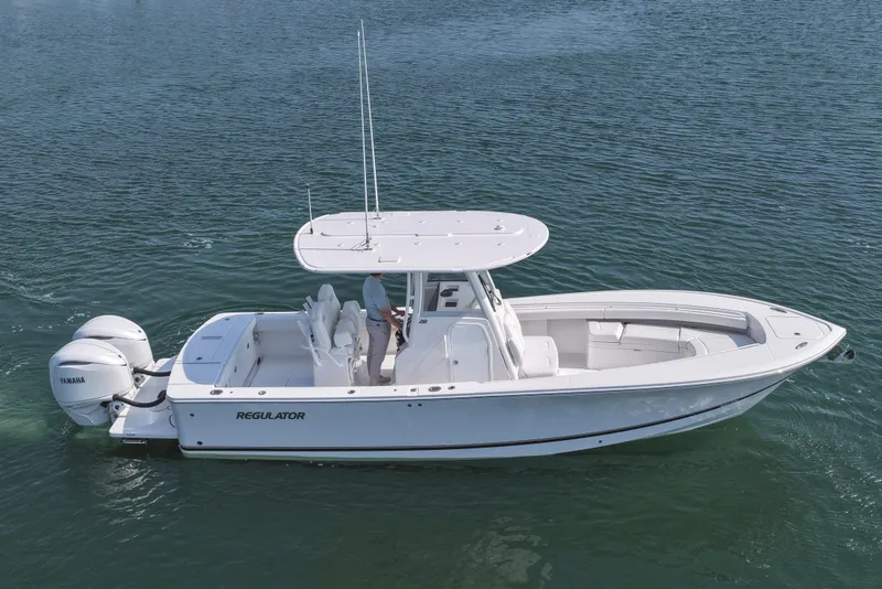 Slide: The Image of 2026 Regulator 28 boat on water with Yamaha engines, side view. - 15