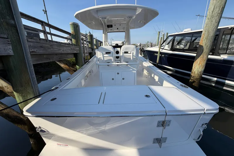 Slide: The Image of 2026 Regulator 28 boat docked, showcasing spacious deck and seating area. - 18
