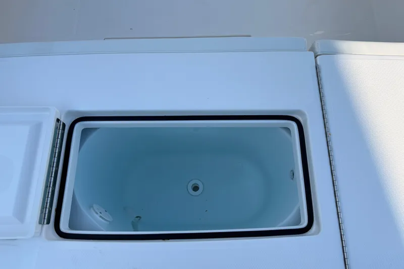 Slide: The Image of Livewell on 2026 Regulator 28 boat, open lid, white interior. - 19