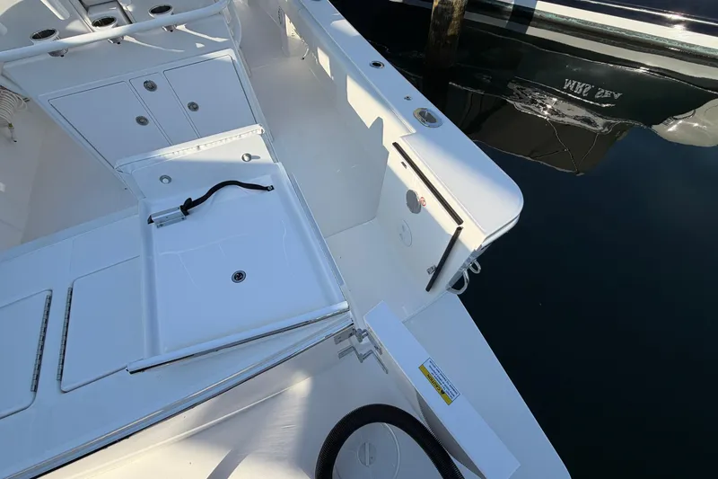 Slide: The Image of 2026 Regulator 28 boat deck with storage compartments and clean white finish. - 21