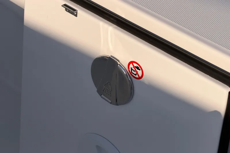 Slide: The Image of 2026 Regulator 28 boat detail with shower symbol and warning sticker. - 22