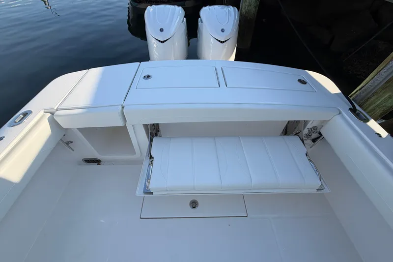 Slide: The Image of 2026 Regulator 28 boat with white seating and dual engines at dock. - 24