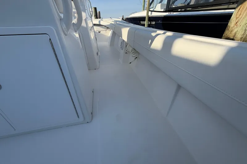 Slide: The Image of 2026 Regulator 28 boat interior with white seating and storage compartments. - 32