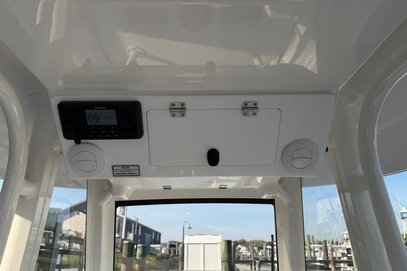 Slide: The Image of 2026 Regulator 28 boat interior with Garmin device and storage compartment. - 35