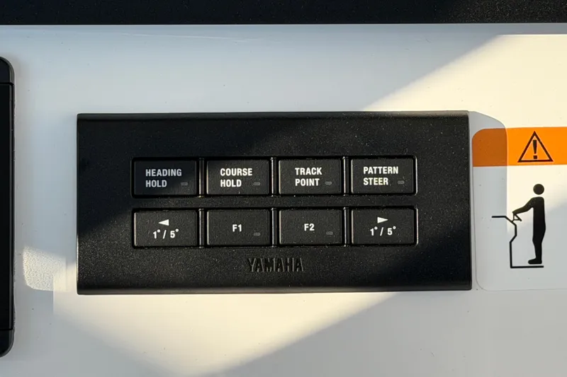 Slide: The Image of Yamaha control panel on 2026 Regulator 28 boat, featuring navigation and steering buttons. - 41