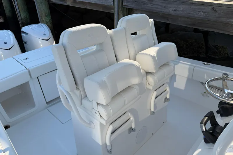 Slide: The Image of 2026 Regulator 28 boat with dual white captain's chairs and Yamaha engines. - 45