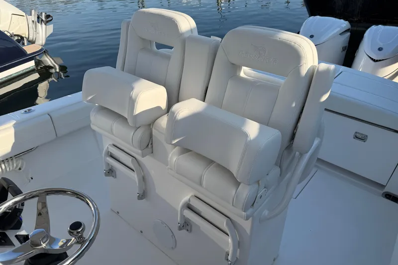 Slide: The Image of Luxury seating on a 2026 Regulator 28 boat, featuring plush white upholstery. - 46