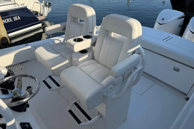 Slide: The Image of 2026 Regulator 28 boat with luxurious white seating and dual cup holders. - 47