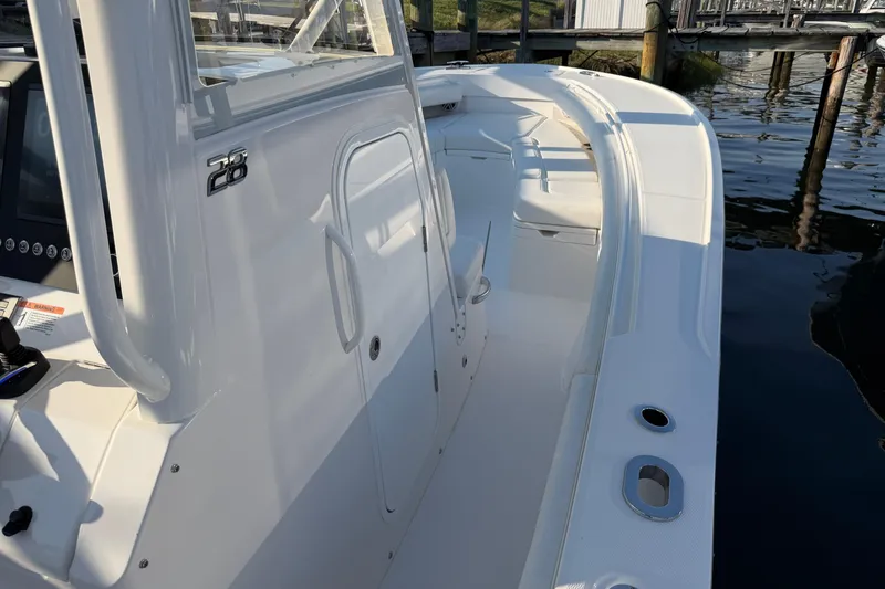 Slide: The Image of 2026 Regulator 28 boat interior, showcasing sleek design and spacious seating near the dock. - 49