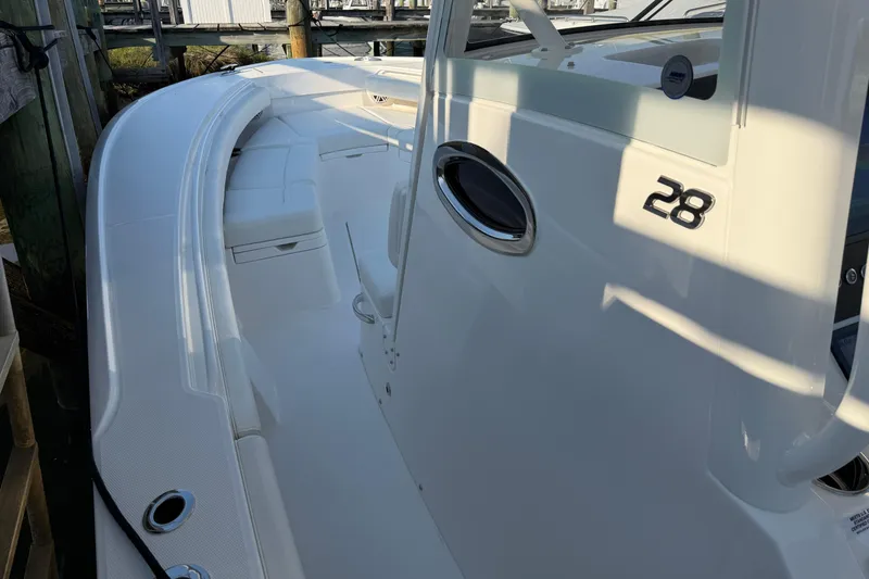 Slide: The Image of 2026 Regulator 28 boat, white deck, docked at marina. - 50