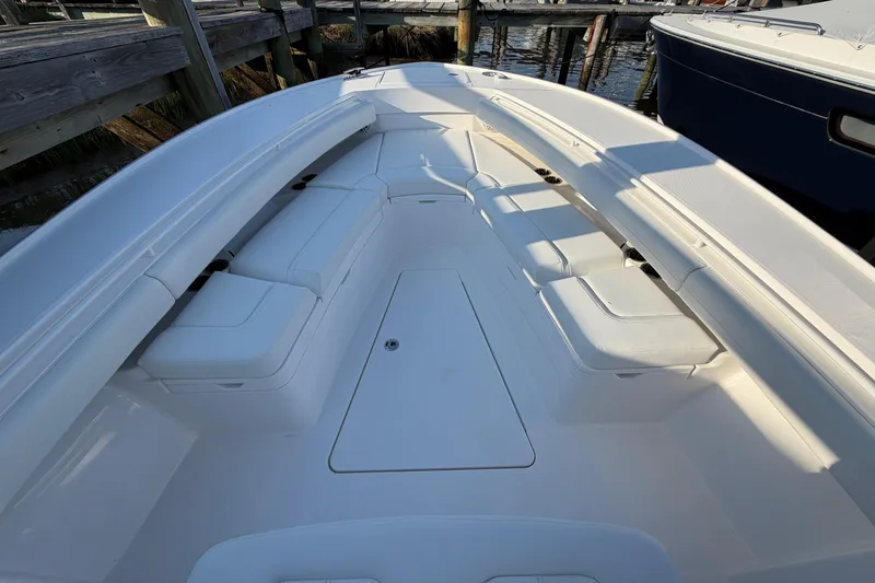 Slide: The Image of 2026 Regulator 28 boat interior with white cushioned seating and sleek design. - 51