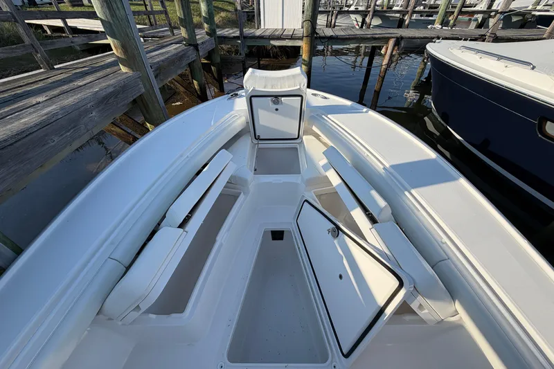 Slide: The Image of 2026 Regulator 28 boat interior with open storage compartments at dock. - 52