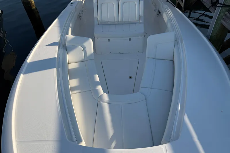 Slide: The Image of 2026 Regulator 28 boat interior with white seating and storage compartments. - 53