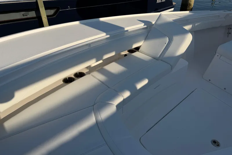 Slide: The Image of 2026 Regulator 28 boat interior with white seating and cup holders. - 54