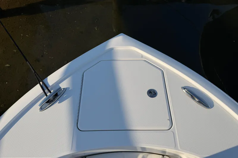 Slide: The Image of Bow of 2026 Regulator 28 boat with storage hatch and cleats. - 56