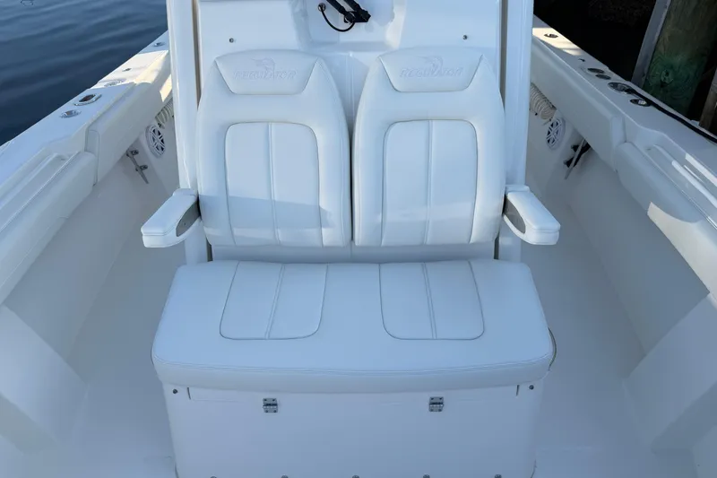 Slide: The Image of 2026 Regulator 28 boat interior with white cushioned seating and armrests. - 60