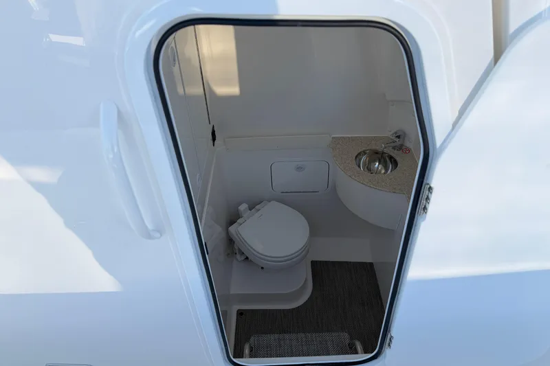 Slide: The Image of 2026 Regulator 28 boat interior with compact bathroom and sink. - 62