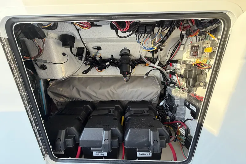 Slide: The Image of Electrical compartment of a 2026 Regulator 28 boat, showcasing batteries and wiring. - 67