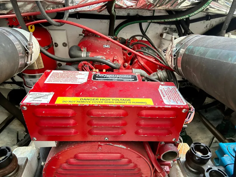 Slide: The Image of Engine compartment of a 2004 Tiara Yachts 3200 Open, featuring a red generator. - 22