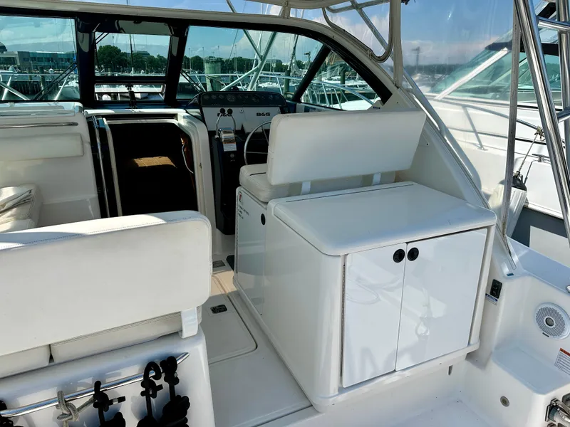 Slide: The Image of 2004 Tiara Yachts 3200 Open cockpit with white seating and helm station. - 6