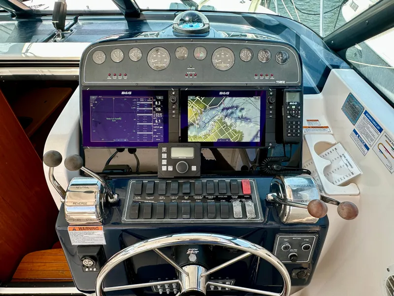Slide: The Image of Helm of 2004 Tiara Yachts 3200 Open with navigation screens and controls. - 7
