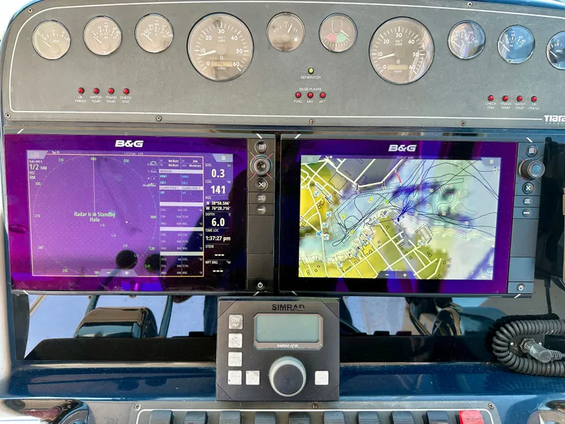Slide: The Image of Dashboard of a 2004 Tiara Yachts 3200 Open with navigation and radar displays. - 8