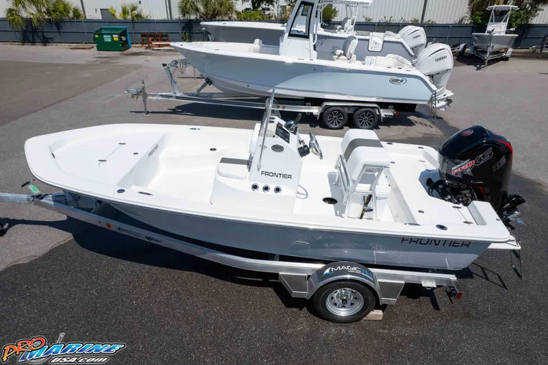Slide: The Image of 2026 Frontier 180 boat on trailer, parked outdoors, with outboard motor. - 10
