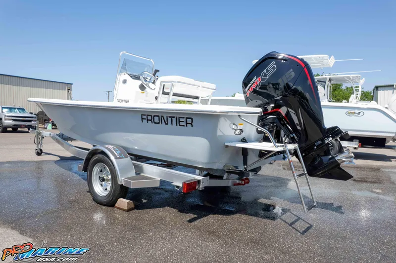 Slide: The Image of 2026 Frontier 180 boat on trailer with powerful outboard motor in a sunny marina. - 11