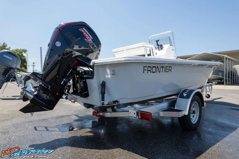 Slide: The Image of 2026 Frontier 180 boat on trailer with powerful outboard motor in sunny dealership lot. - 15