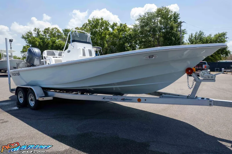 Slide: The Image of 2026 Frontier 180 boat on trailer, parked outdoors under a clear sky. - 23