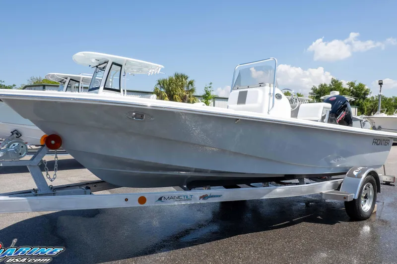Slide: The Image of 2026 Frontier 180 boat on trailer, sleek design, sunny day, ready for adventure. - 7