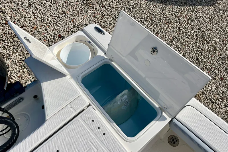 Slide: The Image of Open storage compartments on a 2026 Robalo 226 Cayman boat, showcasing interior features. - 12
