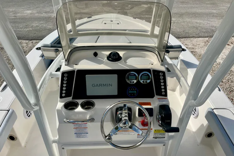 Slide: The Image of 2026 Robalo 226 Cayman boat dashboard with Garmin navigation system and steering wheel. - 15