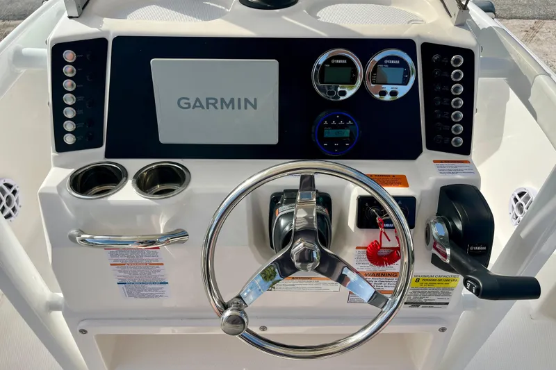 Slide: The Image of 2026 Robalo 226 Cayman boat dashboard with Garmin display and Yamaha controls. - 16