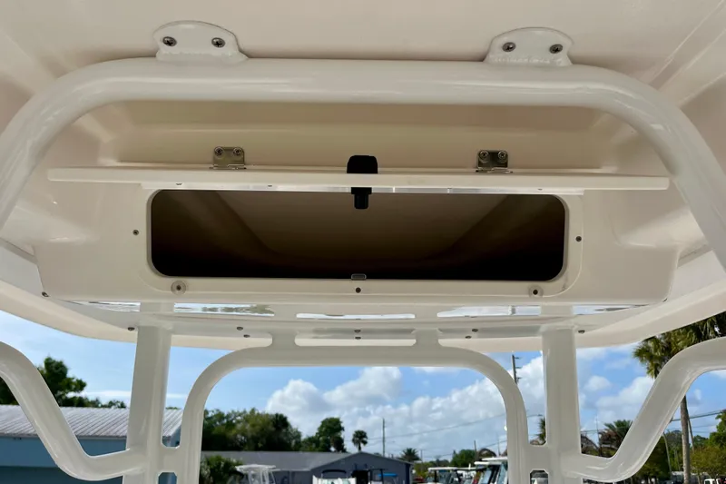 Slide: The Image of 2026 Robalo 226 Cayman boat storage compartment with open hatch, showcasing interior space. - 17