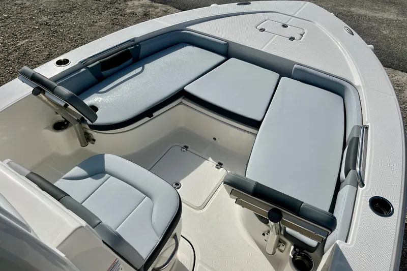 Slide: The Image of 2026 Robalo 226 Cayman boat interior with cushioned seating and sleek design. - 18