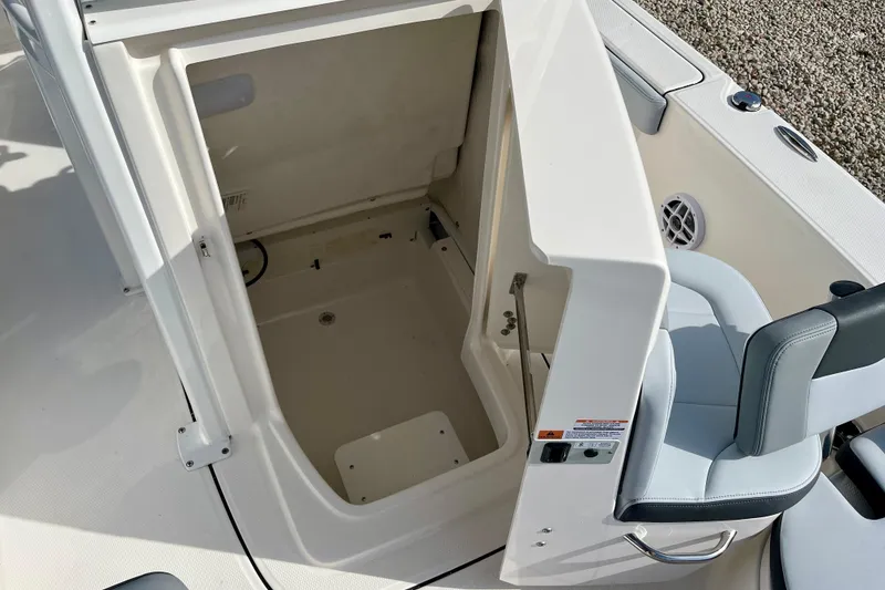 Slide: The Image of 2026 Robalo 226 Cayman boat interior storage compartment with seating area. - 20
