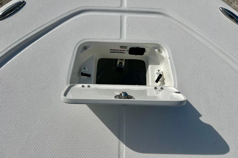 Slide: The Image of Open storage compartment on 2026 Robalo 226 Cayman boat deck. - 25