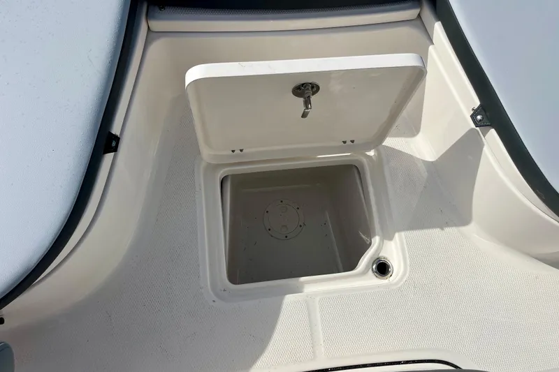 Slide: The Image of Open storage compartment on 2026 Robalo 226 Cayman boat deck. - 26