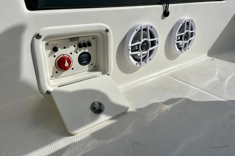 Slide: The Image of Control panel and speakers on a 2026 Robalo 226 Cayman boat deck. - 27