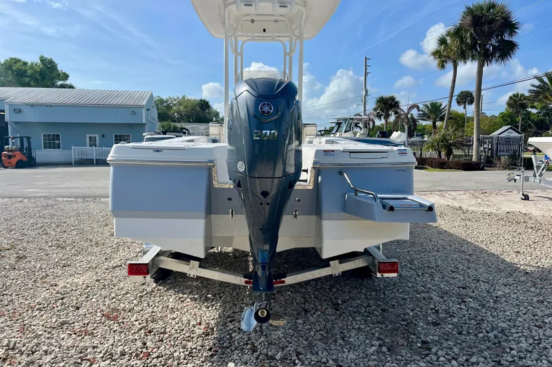 Slide: The Image of 2026 Robalo 226 Cayman boat with Yamaha engine, parked on gravel lot. - 7