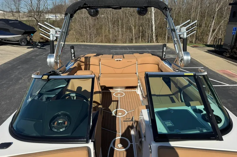 Slide: The Image of 2018 MasterCraft XT22 boat with tan interior and sleek design, parked outdoors. - 11