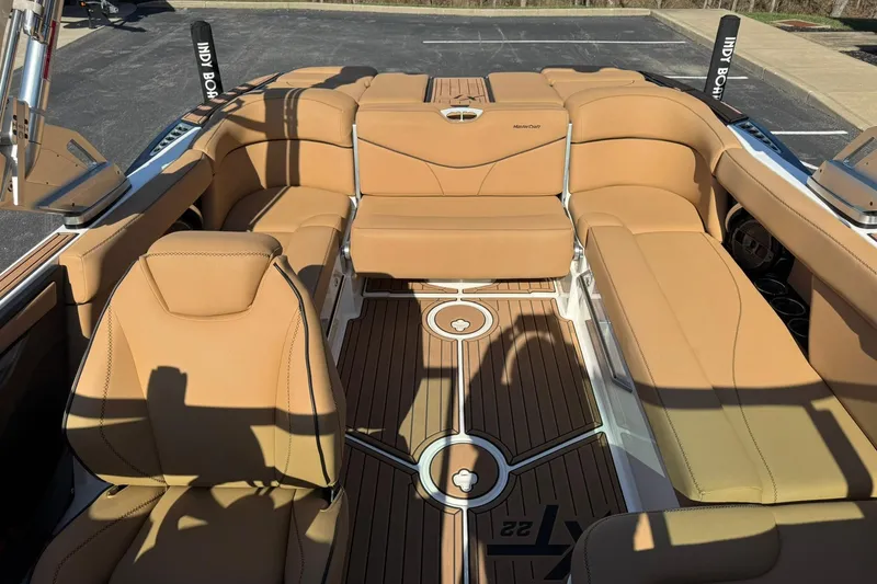 Slide: The Image of 2018 MasterCraft XT22 boat interior with tan leather seating and teak flooring. - 14