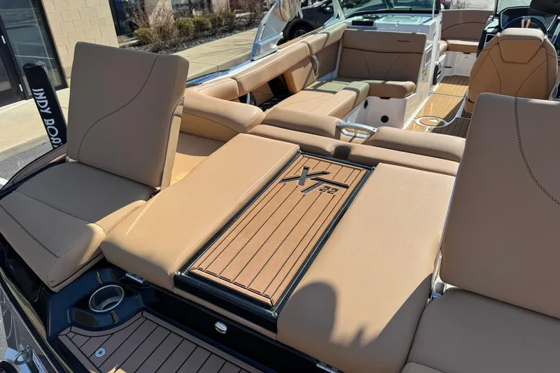 Slide: The Image of 2018 MasterCraft XT22 boat interior with tan seating and teak flooring. - 16