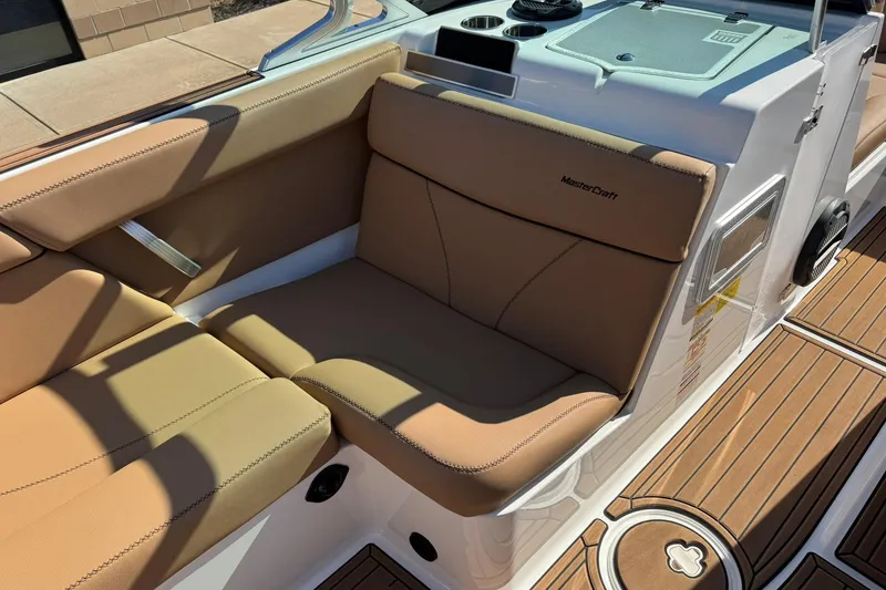 Slide: The Image of 2018 MasterCraft XT22 boat interior with tan seating and teak-style flooring. - 21