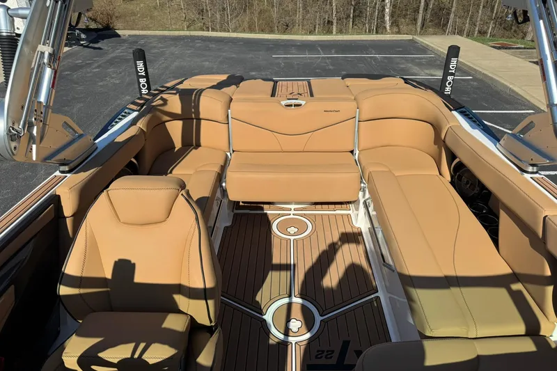 Slide: The Image of 2018 MasterCraft XT22 boat interior with tan leather seating and teak flooring. - 22