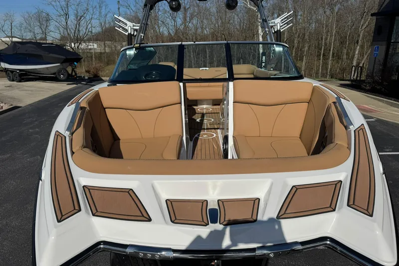 Slide: The Image of 2018 MasterCraft XT22 boat with tan seating and sleek design, parked outdoors. - 8