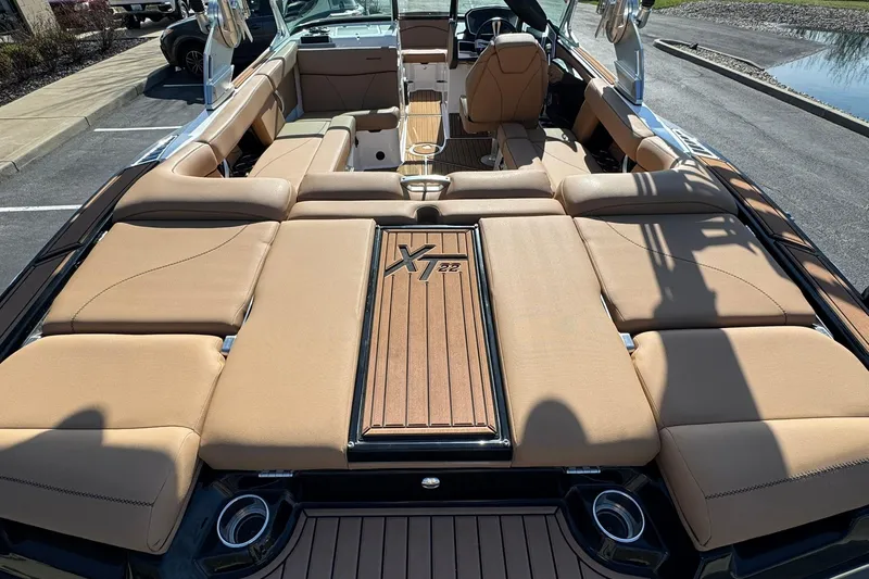 Slide: The Image of 2018 MasterCraft XT22 boat interior with tan seating and sleek design. - 9