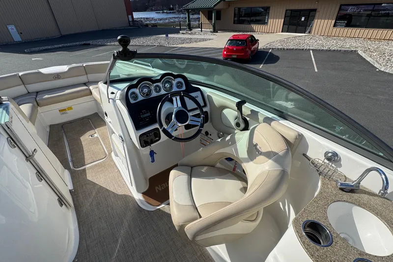 Slide: The Image of 2017 NauticStar 243DC Sport Deck boat interior with steering wheel and seating area. - 10