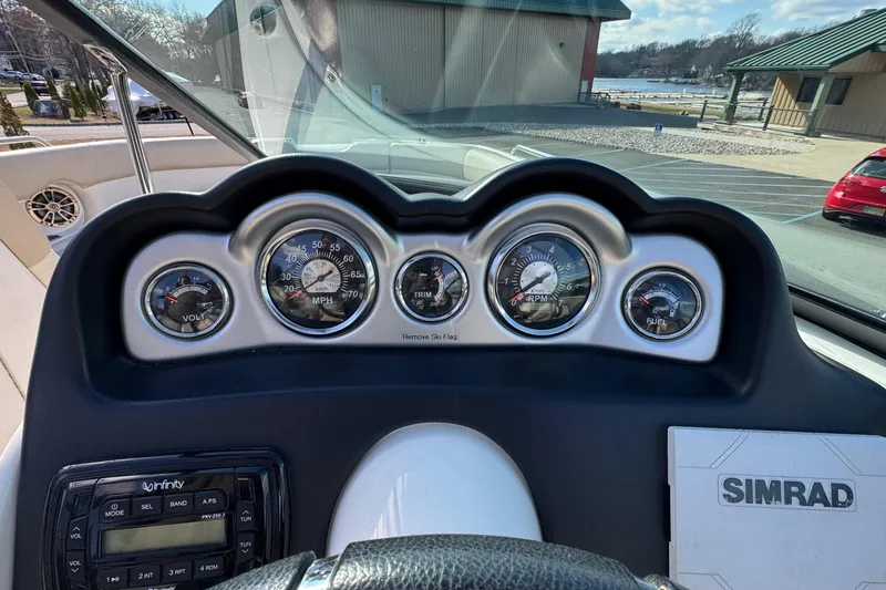 Slide: The Image of Dashboard of a 2017 NauticStar 243DC Sport Deck with gauges and controls. - 11